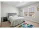 Bright bedroom with a large window, gray headboard bed, and a fun gaming themed rug at 3987 Meandering Bay Dr, Apopka, FL 32712