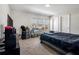 Bedroom with TV, neutral walls, and a queen-sized bed in a cozy atmosphere with natural light at 3987 Meandering Bay Dr, Apopka, FL 32712