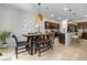 Open dining area featuring modern decor and a stylish woven pendant light at 3987 Meandering Bay Dr, Apopka, FL 32712