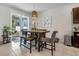 Cozy dining area with a modern table, stylish chairs, bench seating, and sliding glass doors at 3987 Meandering Bay Dr, Apopka, FL 32712