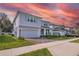 Charming two-story home boasts a brick-paved driveway, attached garage, and beautifully landscaped front yard at 3987 Meandering Bay Dr, Apopka, FL 32712