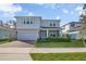 Charming two-story home boasts a brick-paved driveway, attached garage, and beautifully landscaped front yard at 3987 Meandering Bay Dr, Apopka, FL 32712