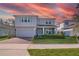 Charming two-story home boasts a brick-paved driveway, attached garage, and beautifully landscaped front yard at 3987 Meandering Bay Dr, Apopka, FL 32712