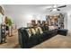 Spacious game room featuring a comfortable sectional sofa, arcade games, and built-in shelving with collectibles at 3987 Meandering Bay Dr, Apopka, FL 32712