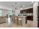 Open kitchen featuring dark cabinets, a quartz countertop island with seating, and pendant lighting at 3987 Meandering Bay Dr, Apopka, FL 32712