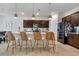 Beautiful kitchen with a quartz countertop island featuring seating and dark cabinets at 3987 Meandering Bay Dr, Apopka, FL 32712