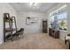 Cozy living room is carpeted and illuminated by a window, creating a tranquil and welcoming atmosphere at 3987 Meandering Bay Dr, Apopka, FL 32712