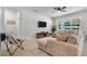 Spacious living room featuring a large sectional sofa, entertainment center, and abundant natural light at 3987 Meandering Bay Dr, Apopka, FL 32712