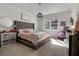 Cozy main bedroom with carpet, natural light and stylish decor at 3987 Meandering Bay Dr, Apopka, FL 32712
