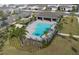 Community pool with lounge chairs, covered seating area, and nearby palm trees at 3987 Meandering Bay Dr, Apopka, FL 32712