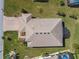 An aerial view showcases a home with lush landscaping, three car garage, and pristine roof at 4311 Via Cavour Ct, Kissimmee, FL 34759
