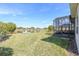 Serene backyard featuring a screened-in lanai overlooking a peaceful pond and lush green lawn at 4311 Via Cavour Ct, Kissimmee, FL 34759