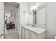 Bathroom with a large mirror and a view of the kitchen featuring a marble countertop at 4311 Via Cavour Ct, Kissimmee, FL 34759
