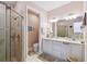 Bathroom featuring a glass enclosed shower and double sink vanity at 4311 Via Cavour Ct, Kissimmee, FL 34759