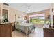 Bright bedroom with a view of a lake and a large window at 4311 Via Cavour Ct, Kissimmee, FL 34759