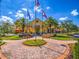 Elegant clubhouse with flags, palm trees, and meticulous landscaping at 4311 Via Cavour Ct, Kissimmee, FL 34759