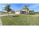 Well-manicured lawn leads to a welcoming single-story home with a screened-in porch and a spacious two-car garage at 4311 Via Cavour Ct, Kissimmee, FL 34759