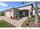 Charming single-story home with beautifully landscaped front yard and screened-in porch at 4311 Via Cavour Ct, Kissimmee, FL 34759
