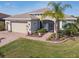 Attractive single-Gathering home with verdant lawn and landscaped entry featuring a paver walkway and a charming screen door at 4311 Via Cavour Ct, Kissimmee, FL 34759
