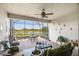 Relaxing screened-in lanai with brick flooring, ceiling fan, and tranquil views of the water at 4311 Via Cavour Ct, Kissimmee, FL 34759