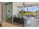 Screened-in lanai with seating areas and views of a pond at 4311 Via Cavour Ct, Kissimmee, FL 34759