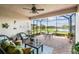 Cozy screened lanai with brick flooring, comfortable seating, and a beautiful view of the lake at 4311 Via Cavour Ct, Kissimmee, FL 34759