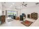 Open living room with lots of seating, ceiling fans, and a view of the screened-in lanai at 4311 Via Cavour Ct, Kissimmee, FL 34759