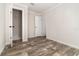 Light-filled bedroom featuring wood look floors, closet, and fresh paint at 4626 Bunting Ave, Orlando, FL 32812