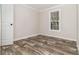 This bedroom showcases stylish wood look flooring and a bright window with natural light at 4626 Bunting Ave, Orlando, FL 32812