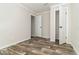 Inviting bedroom with wood-look floors, neutral paint, and closet access at 4626 Bunting Ave, Orlando, FL 32812