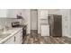 This bright kitchen features stainless appliances, granite counters and white cabinets at 4626 Bunting Ave, Orlando, FL 32812