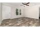 Open living room with wood look floors, ceiling fan, and natural light streaming through windows at 4626 Bunting Ave, Orlando, FL 32812