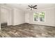 Bright living room features new wood-look floors, crown moulding, and lots of natural light at 4626 Bunting Ave, Orlando, FL 32812