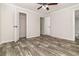 Spacious main bedroom with wood-look floors, ceiling fan and ensuite bathroom at 4626 Bunting Ave, Orlando, FL 32812