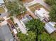 Aerial view shows the property among lush trees, a driveway with multiple cars, and neighboring homes at 528 S 8Th St, Lake Wales, FL 33853