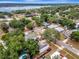 An aerial shot of the neighborhood with views of a large lake nearby, mature trees, and nearby homes at 528 S 8Th St, Lake Wales, FL 33853