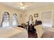Cozy bedroom featuring hardwood floors, neutral walls, and arched windows providing ample natural light at 528 S 8Th St, Lake Wales, FL 33853