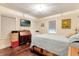 Bright bedroom featuring a bed with wooden frame, television, chest, and windows for natural light at 528 S 8Th St, Lake Wales, FL 33853