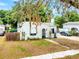 Charming white home with green trim, arched doorway, awning, flagpole, and unique textured facade at 528 S 8Th St, Lake Wales, FL 33853