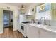 Functional kitchen with white appliances, laminate wood floors, and a double-basin sink at 528 S 8Th St, Lake Wales, FL 33853