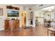 Bright living room featuring hardwood floors, an entertainment center, and access to the dining room at 528 S 8Th St, Lake Wales, FL 33853