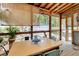 Relaxing outdoor patio featuring a table with blue metal chairs, and screened in porch overlooking the backyard at 528 S 8Th St, Lake Wales, FL 33853