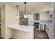 Modern kitchen with stainless steel appliances, white cabinets, and sleek countertops at 628 Eastwood Ct, Altamonte Springs, FL 32714
