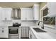 Well-equipped kitchen with stainless appliances, modern faucet, and white countertops at 628 Eastwood Ct, Altamonte Springs, FL 32714