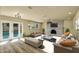 Spacious living room with fireplace, wood floors and French doors to outdoor patio at 628 Eastwood Ct, Altamonte Springs, FL 32714