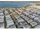 Expansive aerial shot of a mobile home community with lake views, offering a serene lifestyle at 6719 Canterbury Ne Dr, Winter Haven, FL 33881