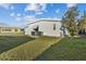 A view of the back side of the house with lush green grass at 6719 Canterbury Ne Dr, Winter Haven, FL 33881