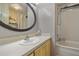 Bathroom with modern vanity, oval mirror, shower and tub combination at 6719 Canterbury Ne Dr, Winter Haven, FL 33881