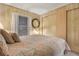 Cozy bedroom features a comfortable bed, side table, and a round wall mirror at 6719 Canterbury Ne Dr, Winter Haven, FL 33881