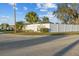 Community entrance sign with lush landscaping and a glimpse of homes at 6719 Canterbury Ne Dr, Winter Haven, FL 33881